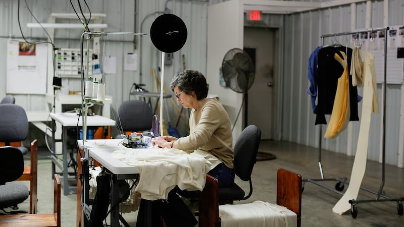A member of the team sews in the Alabama Chanin workspace.