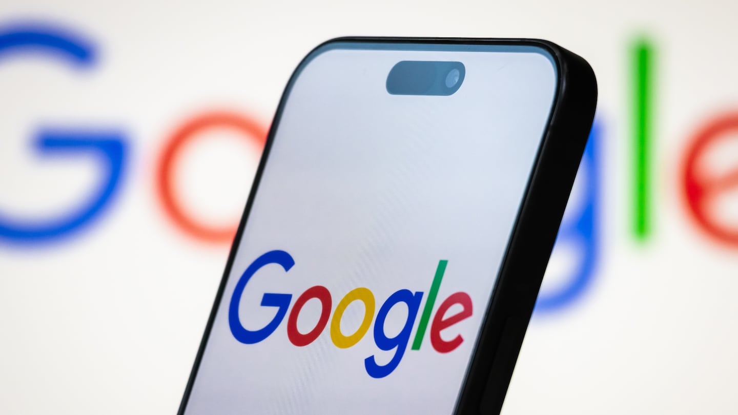 In this photo illustration, the Google logo is displayed on a smartphone screen, with the colorful Google branding seen in the background.