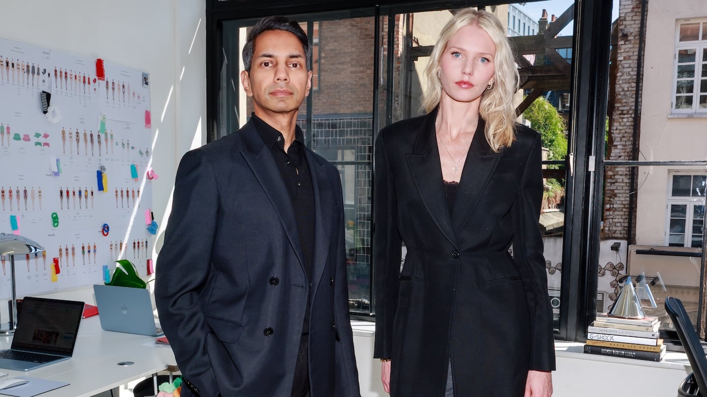 A portrait of Hunza G CEO Krishna Nikhil and creative director Georgiana Huddart standing in the brand's London office.